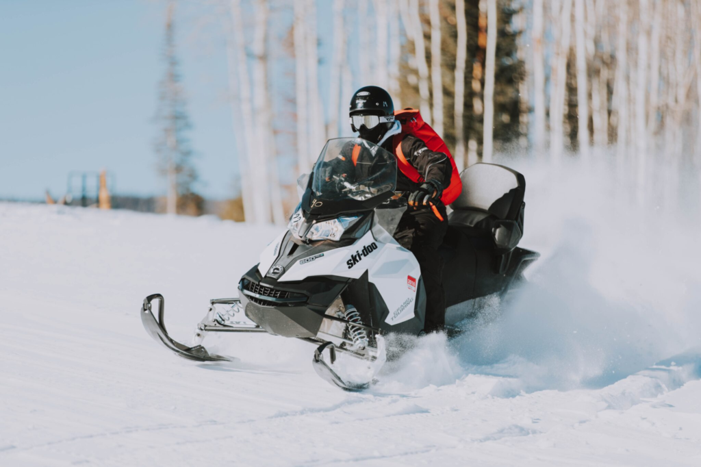 Snowmobilers blazing a trail with Lake Superior in the distance