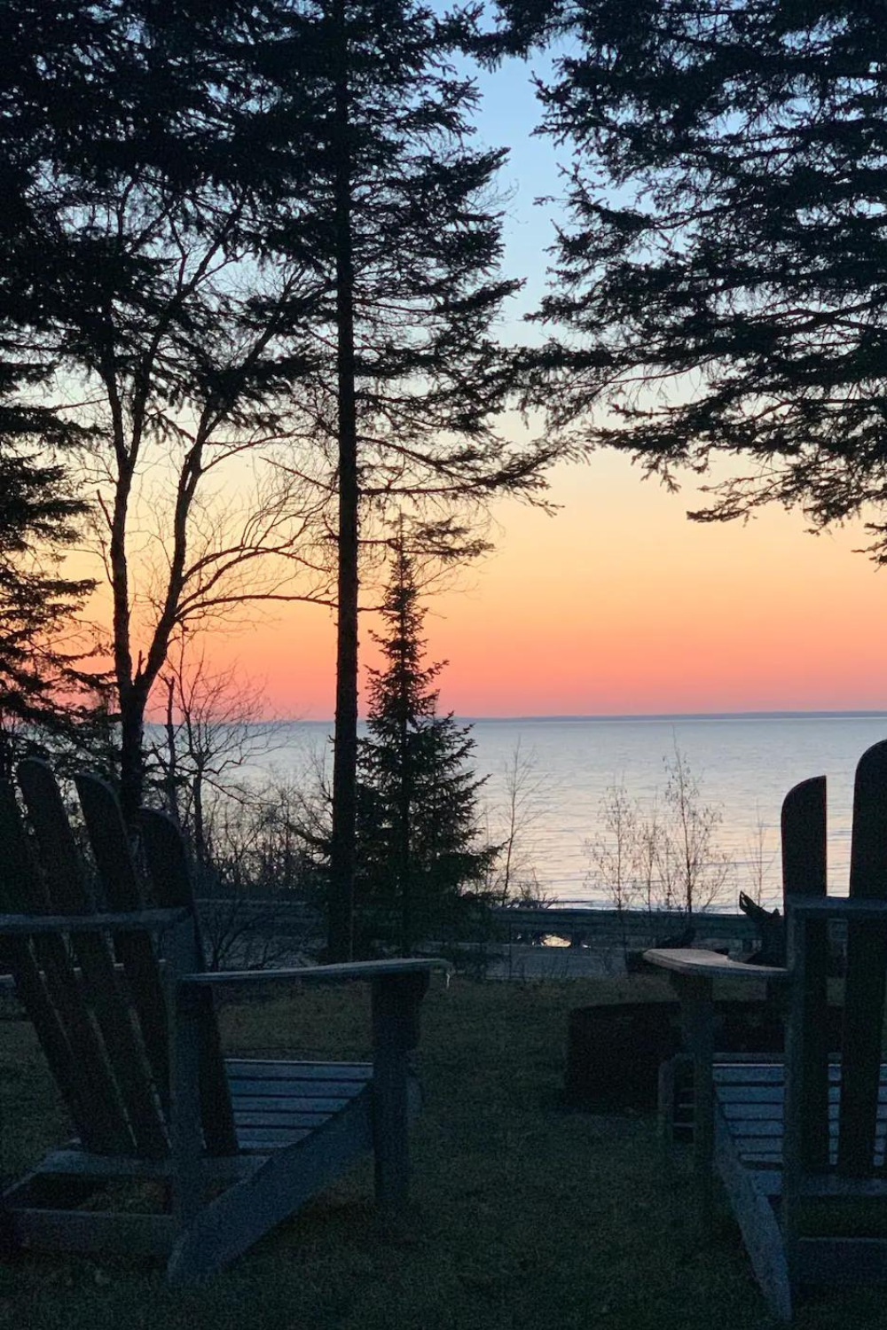 Superior Shores retreat viewed from Lake Superior, featuring sandy beaches and dense northern forests" Caption: