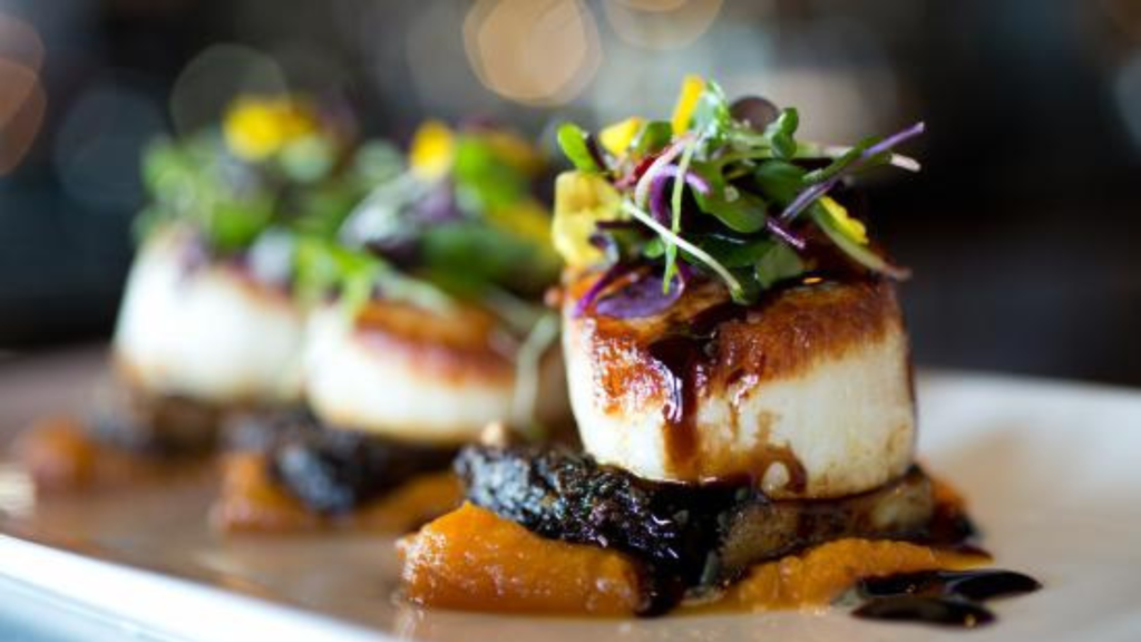 A beautifully plated dish featuring fresh fish from Lake Superior, complemented by local vegetables and garnishes.